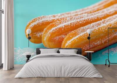 Traditional Spanish and Mexican dessert churros fresh baked on blue background. Sugar crispy dessert, churros with powdered sugar coating Wall mural