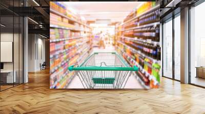 Shopping trolley in supermarket store Wall mural