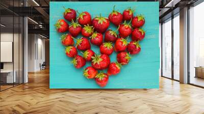 Strawberry on a turquoise background wooden heart-shaped. Top view Wall mural