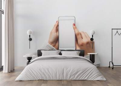 A close-up shows a woman's hands using a smartphone with a blank screen, against a plain white background, suitable for displaying graphics or text. Wall mural