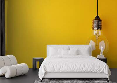 A single hanging light bulb displayed against a yellow background, symbolizing creativity or the concept of a bright idea. Wall mural