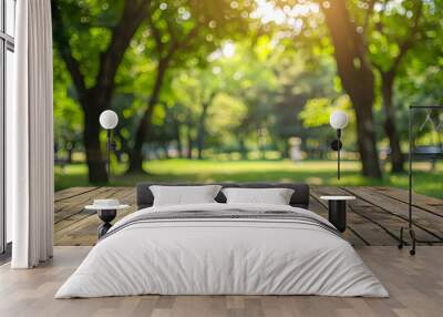 Empty wood tabletop with a blurred green tree in the park garden background; suitable for product display or montage. Wall mural