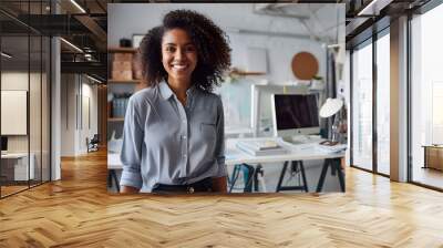 Happy female designer standing in an office. Wall mural