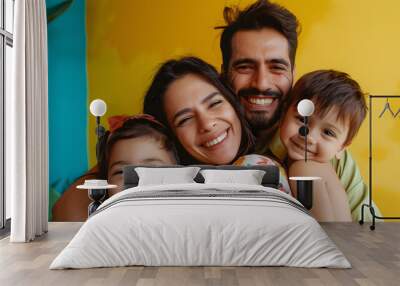 Portrait of a happy family against a color background Wall mural