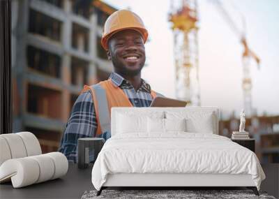 Smiling building contractor using digital tablet while standing at construction site Wall mural