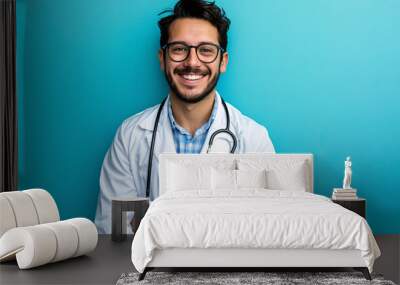 Young doctor man over isolated blue wall smiling a lot Wall mural