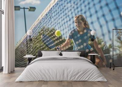 Young Woman Playing Pickleball at the Pickleball Court: A young woman actively  Wall mural