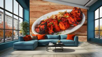 Assorted indian food Chicken angara kebab on wooden background. Dishes and appetizers of indian cuisine, selective focus Wall mural