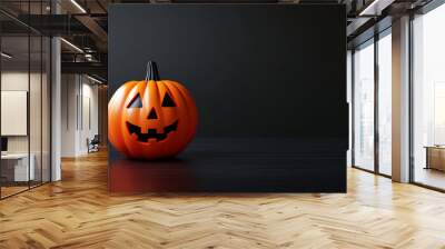 A carved Halloween pumpkin with a smiling face on a black background Wall mural