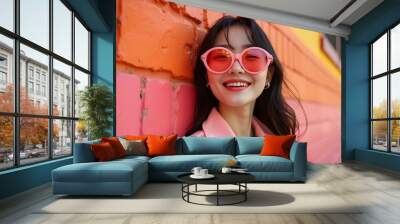 photoshoot of an elegant a Asian woman wearing sunglasses and stylish , standing in front of colorful abstract shapes Wall mural