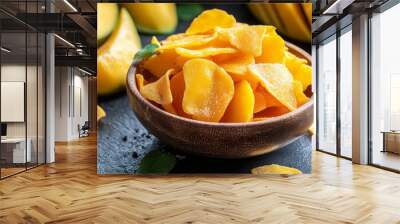 
A composition featuring dried mango chips alongside fresh sliced mango creates a beautiful contrast between the textures and colors of the fruit in its two different forms Wall mural