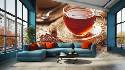 A cup of flavorful rooibos tea sits on a wooden table, inviting you to enjoy its rich aroma and soothing taste. The warm hue of the tea contrasts beautifully with the natural wood, creating a cozy atm Wall mural