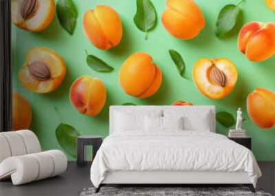 Apricot pattern. Trendy summer background. Ripe fresh apricots on a green background. Top view, flat lay. Ideal for summer sales, advertising, wrapping paper, posters, greeting cards, and cover backgr Wall mural