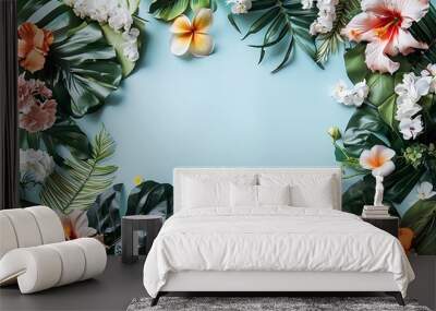 Creative layout made of tropical leaves and flowers on blue background. Flat lay. Nature concept. Wall mural