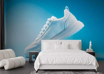 Pair of white sneakers isolated on blue background. 3d rendering Wall mural