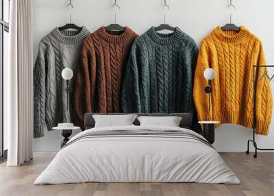 warm sweaters hanging against a white background.