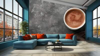 “A cup of hot chocolate against a grey stone background. The warm, rich beverage contrasts beautifully with the cool, textured stone, emphasizing the comforting appeal of the hot chocolate Wall mural