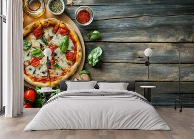 “Pizza and its ingredients arranged on a wooden table. The scene includes a freshly baked pizza alongside various ingredients such as tomatoes, mozzarella cheese, herbs, and mushrooms,  Wall mural