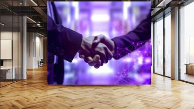 Handshake between business people on purple background with glowing lights Wall mural