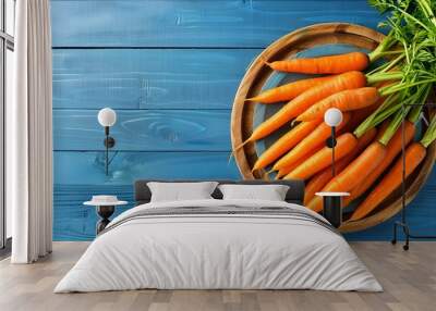 Bunch of fresh organic carrots on blue wooden background Wall mural