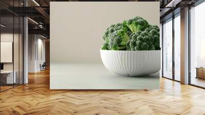 Fresh green broccoli in a white bowl on a light background Wall mural