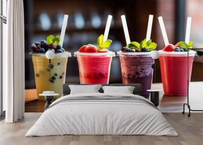 Fruit smoothies in plastic cups on wooden table in kitchen. Wall mural