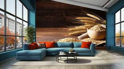 wheat in bowl and ears of wheat on a wooden background. Wall mural