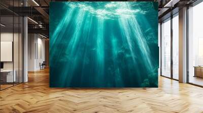 A deep, mysterious underwater cave with beams of light breaking through the water’s surface, creating an eerie and magical underwater world Wall mural