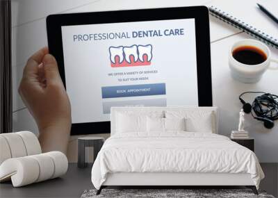 Hand holding tablet with dental care concept on screen Wall mural