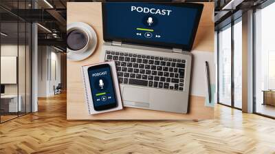 Podcast concept on laptop and smartphone screen over wooden table. All screen content is designed by me. Flat lay Wall mural