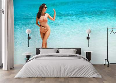 Sensual young woman posing on a beautiful tropical beach Wall mural