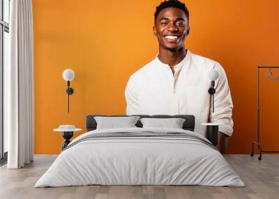 happy african american handsome man wearing fashion white Summer Shirt on orange background with space aspect ratio 16:9 Wall mural