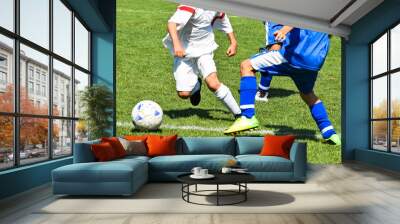 Young soccer players in action Wall mural