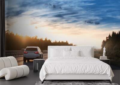 Highway traffic in sunset. Road with metal safety barrier or rail. cars on the asphalt under the cloudy sky Wall mural