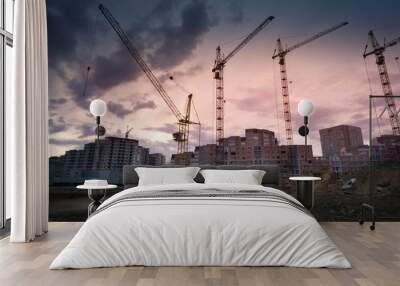 Industrial landscape with silhouettes of cranes over sunset Wall mural