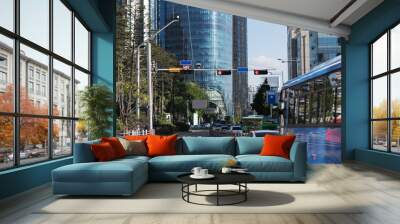 View of modern urban road with many tries, blue blured bus and white car. Public transport in city concept Wall mural