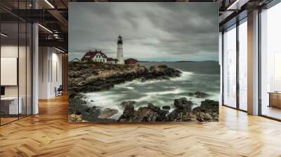 a lighthouse on the coast of New England under a cloudy sky during bad weather Wall mural