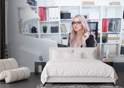 Beautiful girl with glasses working at the computer Wall mural