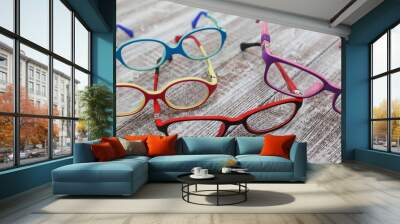 kids colorful eyeglass frames on a light wooden background Wall mural