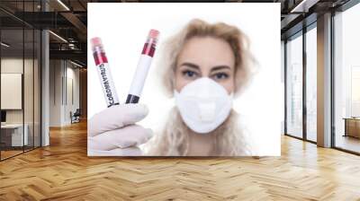 The girl is a doctor with a clean test tube and a blood test tube of a new coronavirus. Epidemic of the disease. Wall mural