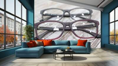 Two pairs of stylish women's eyeglass frames on white wooden background Wall mural