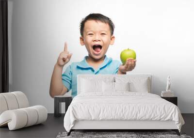 Asian baby boy holding and eating red apple, isolated on white Wall mural