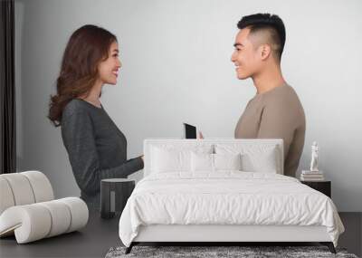 Asian man gives jewelry in a box to his woman Wall mural