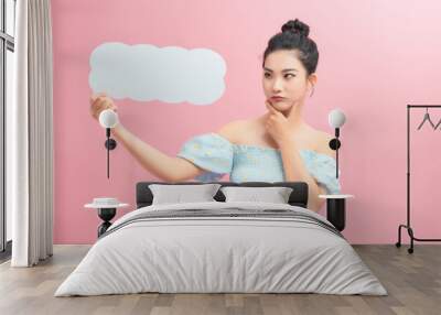 Beautiful woman holding speech bubble in form of cloud with copy space for text. Wall mural