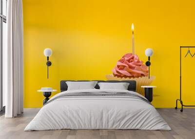 Birthday cupcake with  candle on yellow background. Wall mural