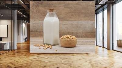 Bottle of soy milk and soybean on wooden table Wall mural