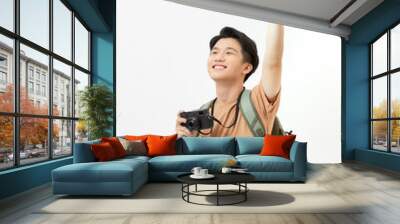 Cheerful male tourist holding travel camera entertainment Wall mural