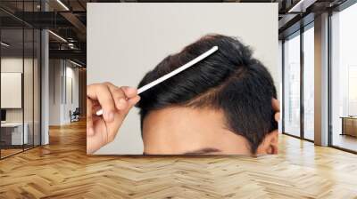 Close up photo of clean healthy man's hair. Young man comb his hair Wall mural