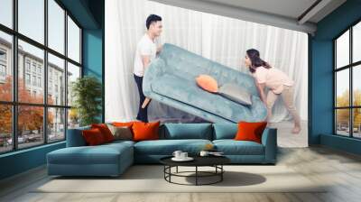 Couple at home relaxing on sofa with digital tablet Wall mural