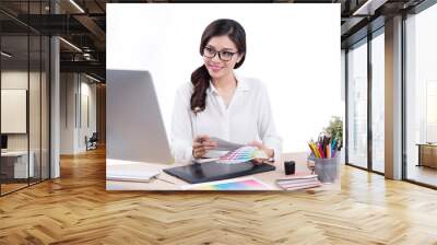 Graphic designer at work. Asian woman sitting on desk. Wall mural